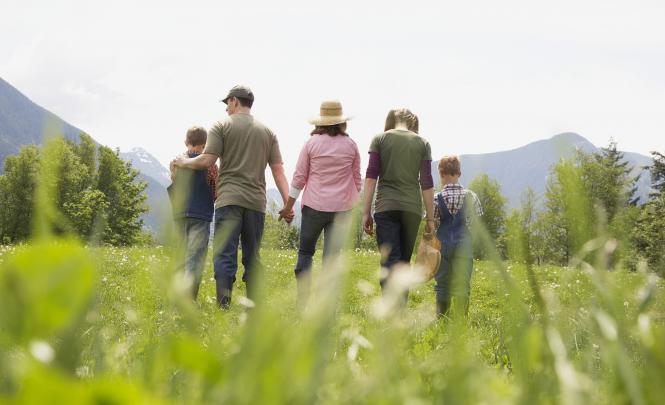 Family walking through grass